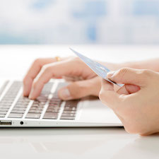 person with credit/debit card buying online