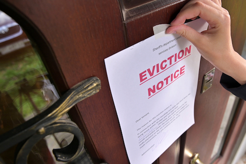 Civil,Servant,Sticks,A,Notice,Of,Eviction,Of,The,Tenant,